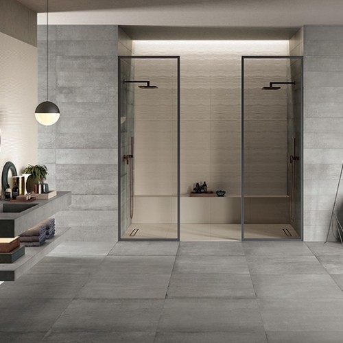 Open badkamer met grijze betonlook tegels