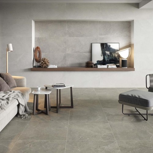 Grijze sofa met stoelen op grijze betonlook tegels